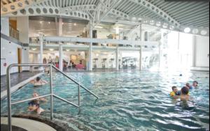 a group of people swimming in a swimming pool at Borwick Lakes Holiday Caravan (Partial Lake View) in Borwick