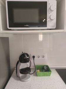 a microwave sitting on top of a kitchen counter at Four Rooms in Valencia