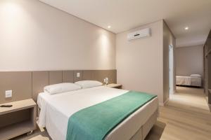 Tri Hotel Executive Osório客房内的一张或多张床位