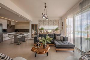 a living room with a couch and a table at Villa Ioulia Gouves in Gouves