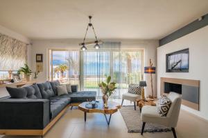 a living room with a couch and a table at Villa Ioulia Gouves in Gouves