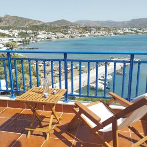 a balcony with a table and chairs and a view of the water at Light Blue in Makry Gialos