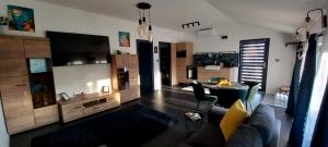 a living room with a couch and a table at AirPortOne in Vecsés