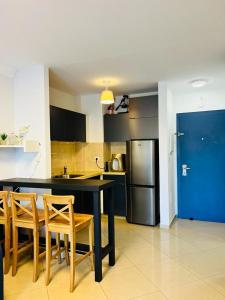 a kitchen with a table and chairs and a refrigerator at pisgat shoresh in Shoresh