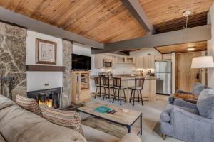 a living room with a couch and a fireplace at Laurelwood Condominiums 311 in Snowmass Village