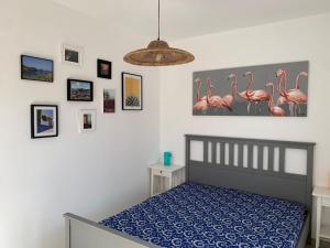 Terrace ini في تيراسيني: غرفة نوم بسرير وصور فلامنغو على الحائط