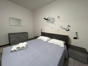 een slaapkamer met een bed met een blauw dekbed bij Como Lake Suite with Terrace & Parking in Como