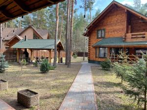 a log house with a walkway in front of it at Greenhousevip in Voropayev