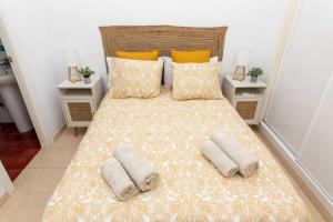 a bedroom with a large bed with two pillows at Apartamento Pedregalejo Playa in Málaga