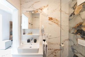 a bathroom with a sink and a glass shower at Hotel & Restaurant Sparta in Oldenburg