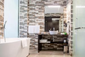 a bathroom with a sink and a mirror at Amaryllis Hotel Blantyre in Blantyre