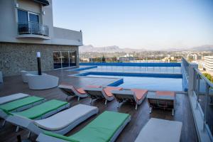 a rooftop deck with chairs and a swimming pool at Amaryllis Hotel Blantyre in Blantyre