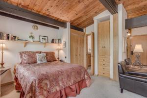 a bedroom with a bed and a desk and a chair at Laurelwood Condominiums 208 in Snowmass Village