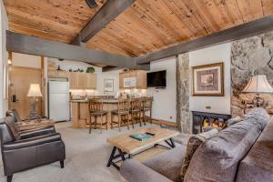 a living room with a couch and a fireplace at Laurelwood Condominiums 208 in Snowmass Village