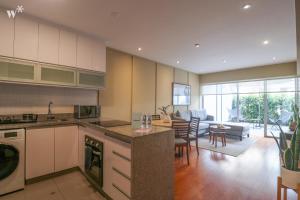a kitchen and living room with a table and chairs at Spectacular 1BR in Miraflores in Lima
