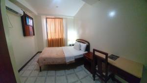 Postel nebo postele na pokoji v ubytování Hotel Cisne II