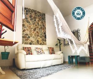 - un salon avec un canapé et un mur en pierre dans l'établissement Casa 9-92 Hotel Boutique, à Guaduas