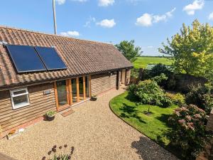 a house with solar panels on the roof at Larks Nest in Wortham
