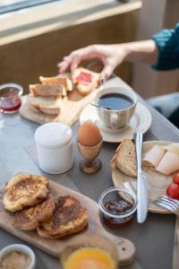 uma mesa coberta com pratos de pão e ovos em Batelo - Adults Only em Benitses