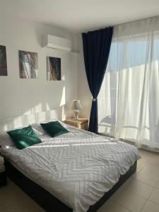 a bedroom with a large bed and a window at Admiral Plaza in Sunny Beach