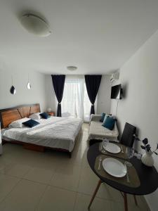 a bedroom with two beds and a table and a couch at Admiral Plaza in Sunny Beach