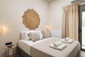 a bedroom with a large bed with towels on it at Limani elegant apartments in Souda