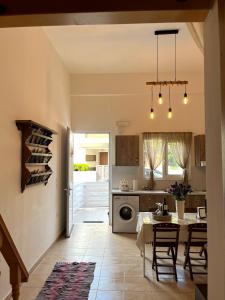 a kitchen and dining room with a table and chairs at Irene’s house in Koskinou