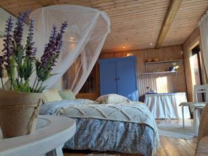 a bedroom with a bed with a canopy at Cosy guesthouse with sauna and outdoor kitchen in Kuressaare