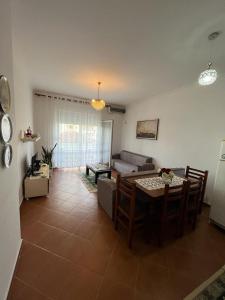 un soggiorno con un tavolo e un divano di Amal Vlora Apartament a Vlorë
