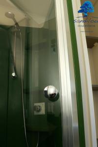 a shower with a shower head in a bathroom at Mobilhome Côté mer - 3 Chambres - Climatisé - TV in Sigean