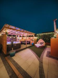 a backyard patio with a gazebo and a tent at Cosy Hot Tub Getaway Bungalow in Armagh
