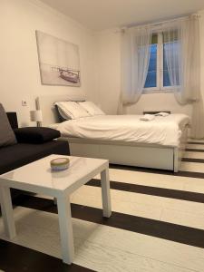 a living room with a bed and a coffee table at Lana apartman in Belgrade