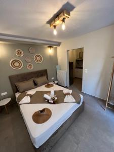 a bedroom with a large bed with hats on it at Villa Maria apartments in Nea Skioni