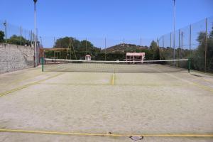a tennis court with a net on top of it at Villa Aurelia - Pool, BBQ & Tennis Court - San Teodoro in San Teodoro