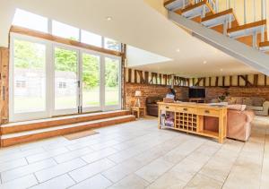 a large living room with a staircase and a couch at Vancouver Barn Sutton in Sutton