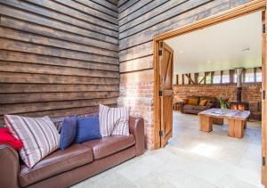 a living room with a couch and a brick wall at Vancouver Barn Sutton in Sutton