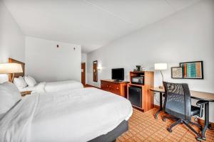 a hotel room with a bed and a desk with a computer at Fairfield Inn by Marriott Lumberton in Lumberton