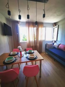 a living room with a table and red chairs at City Center Apartment Bravos in Makarska