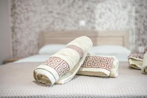 two towels are laying on a bed at Old Town Elpis Suite in Kos Town