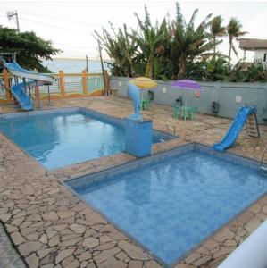 a swimming pool with a slide and a playground at Varandas Lagoa Azul in Araruama