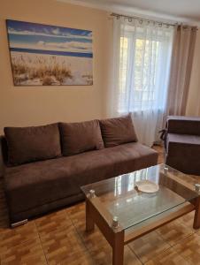 a living room with a couch and a coffee table at Apartamenty MartApart Kołobrzeg in Kołobrzeg