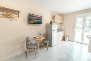 a kitchen with a small table and a refrigerator at Old Town Euphoria Suite in Kos Town +15 photos