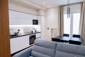 a living room with a blue couch and a kitchen at CALVANI23 LUXURY HOUSE in Bari