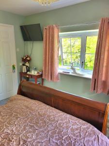 a bedroom with a bed and a window at Canalside B and B 