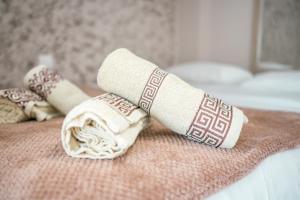 a rolled up towel on top of a bed at Old Town Euphoria Suite in Kos Town