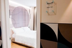 a bedroom with a white bed and a window at CALVANI23 LUXURY HOUSE in Bari