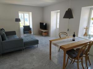 a living room with a table and a couch at Haus Rovina in Münster