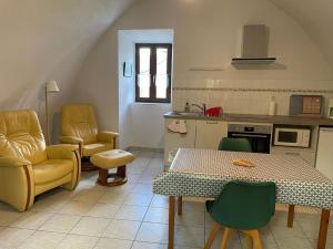 a kitchen with a table and two chairs and a table and a table and chairs at Gite Montalies in Novis