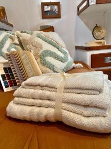 a pile of blankets sitting on top of a bed at Sailing Nights Boat&breakfast in Alghero
