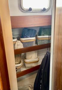 a cupboard with baskets and other items in it at Sailing Nights Boat&breakfast in Alghero